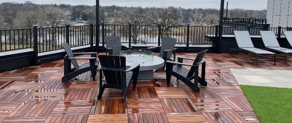 Rooftop patio in Essex County, NJ, with fire pit and chairs.